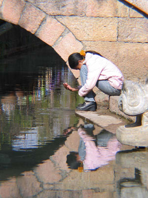 Girl by waterside